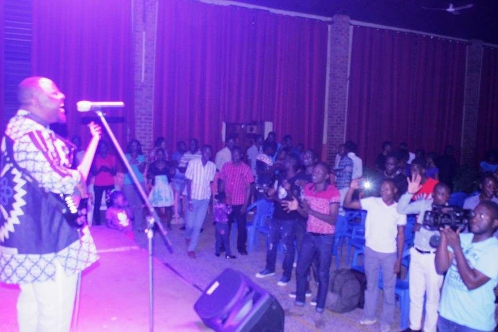 A worship leader singing at a worship night